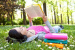 © luckybusiness - relaxing in nature with book and music