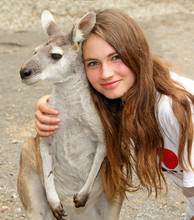 Young Girl Hugging A Kangaroo