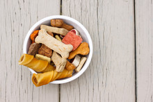 Assortment of dog treats in white bowl