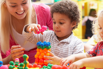 Young woman playing with boy