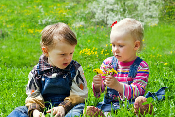 Wall Mural - Boy and girl sitting in the grass