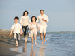 © .shock - happy young family have fun on beach at sunset