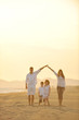 © .shock - happy young family have fun on beach at sunset