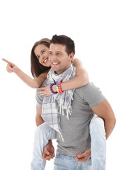 Wall Mural - Happy guy carrying girlfriend on back