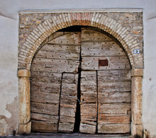 Old Arched Wooden Doorway On White Wall