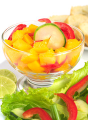 Salad out of mango, red bell pepper, cucumber and lettuce