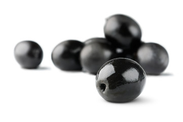 Poster - Isolated olives. Pile of black olive fruits isolated on white background, selective focus