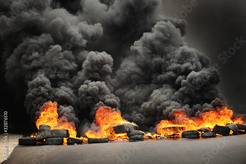 Fotografie, Obraz explosion & burning wheels causing huge dark smoke & pollution