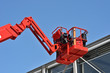 © vlaru - red hydraulic construction cradle against the blue sky