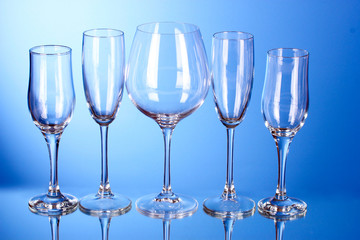 Few empty wine glasses on blue background