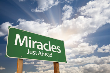 Miracles Green Road Sign Against Clouds