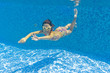 © Iuliia Sokolovska - Happy smiling underwater kid in swimming pool