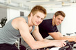 © CandyBox Images - Fitness young man on gym bike spinning