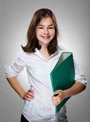 Girl holding book on gray background