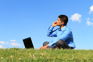 Wall Mural - businessman with laptop and cell phone at the park