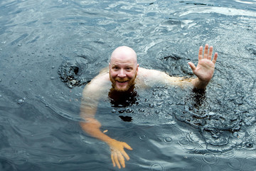 man treading water in a lake