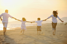 Happy Young Family Have Fun On Beach