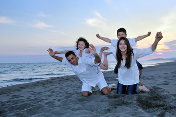 Wall Mural - happy young family have fun on beach