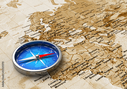 Fototapeta do kuchni Blue metal compass on the old world map