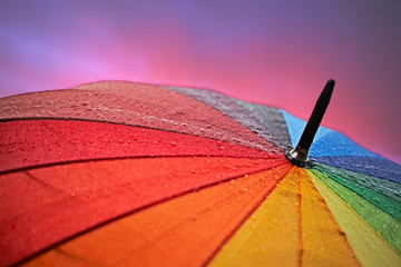 multicolored umbrella and red glowing evening sky