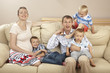 © Andrej Porochnenko - Family sitting on the sofa