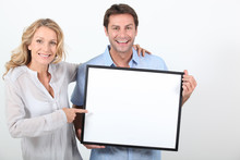 Couple Holding A Blank Board Ready For Image Or Text