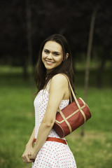 Portrait of charming young smiling woman in glasses on green bac