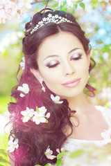 Beautiful bride in a blossoming garden