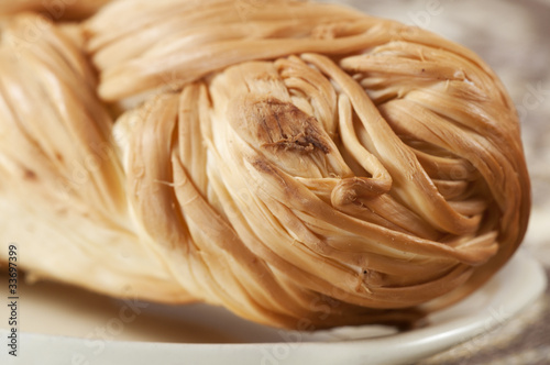 Fotografia, Obraz Smoked "pigtail" cheese, close-up shot, local focus