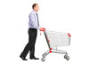 Full length portrait of a man pushing an empty shopping cart