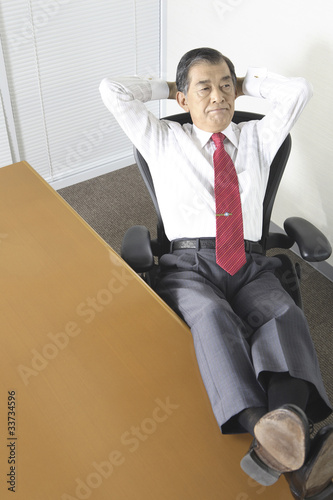 足をデスクに投げ出す社長 Stock Photo Adobe Stock
