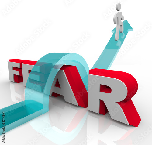 Fotografie, Obraz Conquering Your Fears - Jumping Over Word to Beat Fear