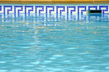 blue water of the pool and mosaic border