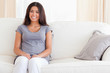 © WavebreakmediaMicro - Smiling Woman sitting on a sofa