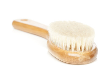 A brown woodem hairbrush