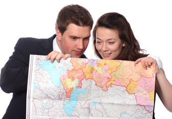 happy casual couple with map isolated on the white