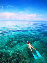 Sticker - Young woman snorkeling in the coral reef in the tropical sea. Bunaken island. Indonesia