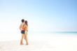 © Dudarev Mikhail - Young man and woman standing on warm sand at sunny day and enjoying each other