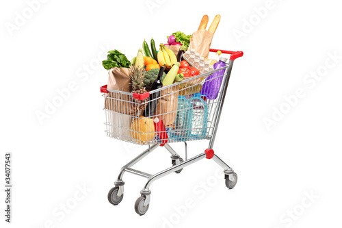 Fotografía A shopping cart full with various groceries