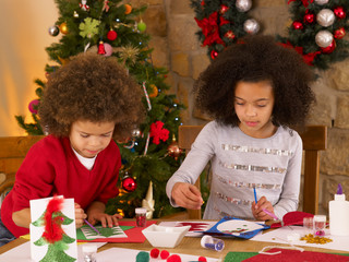 mixed race children making christmas cards