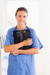 © WavebreakmediaMicro - Cute nurse holding a folder