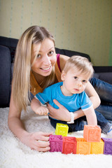 Young mother playing with baby boy