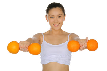 asian woman engaged in fitness of oranges