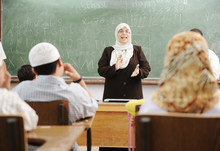 Muslim Female Teacher With Children In School