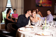 © Daco - happy couple at restaurant table kissing