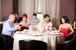 © Daco - young people toasting restaurant table