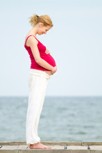 Pregnant Woman On Beach