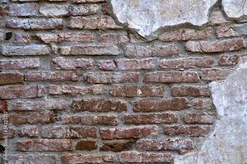 Fényképezés  Old Worn Down Brick Wall with Plaster