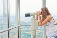 Girl Looking Through Tourist Telescope