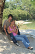 © auremar - Happy couple sat under a tree